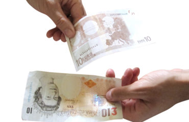 Hands exchanging euro and GBP