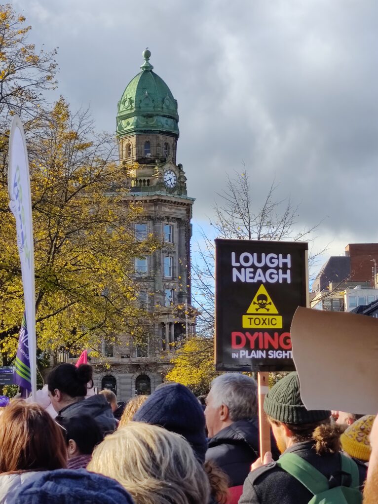 People hold placards at Save our Lough demonstration in Belfast in October 2023